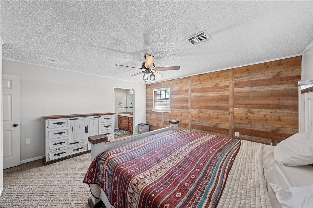 126 Cr 173 Road Marlin, TX 76661 - Photo 20 of 48 a bedroom with a bed and a chandelier