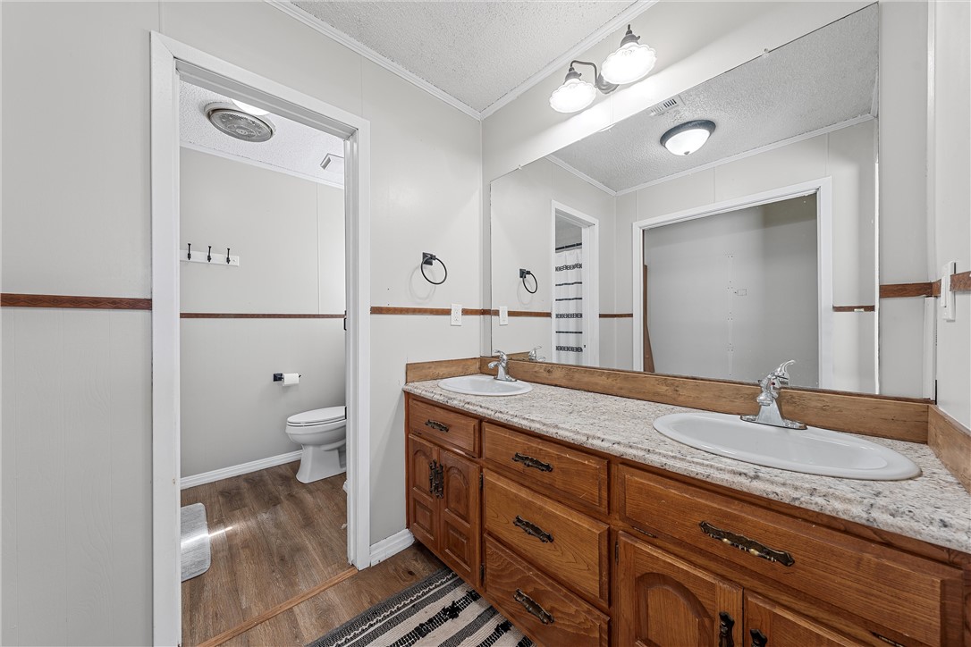 126 Cr 173 Road Marlin, TX 76661 - Photo 21 of 48 a spacious bathroom with a granite countertop double vanity sink mirror and toilet