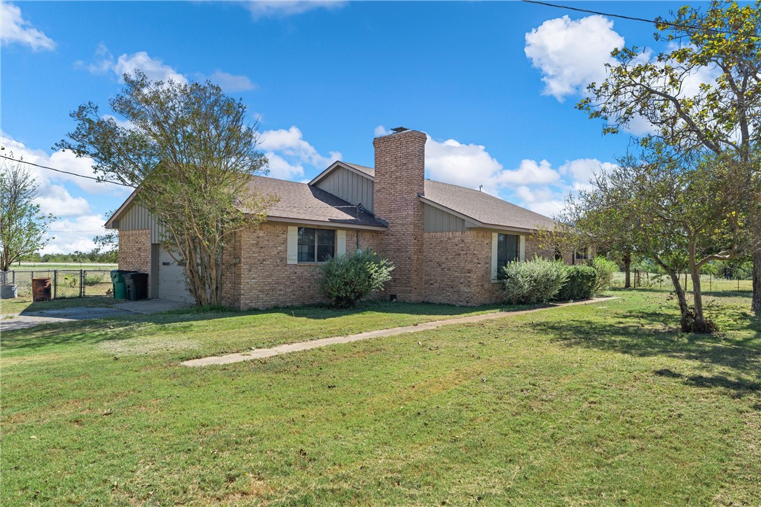 126 Cr 173 Road Marlin, TX 76661 - Photo 3 of 48 a front view of a house with a garden and yard