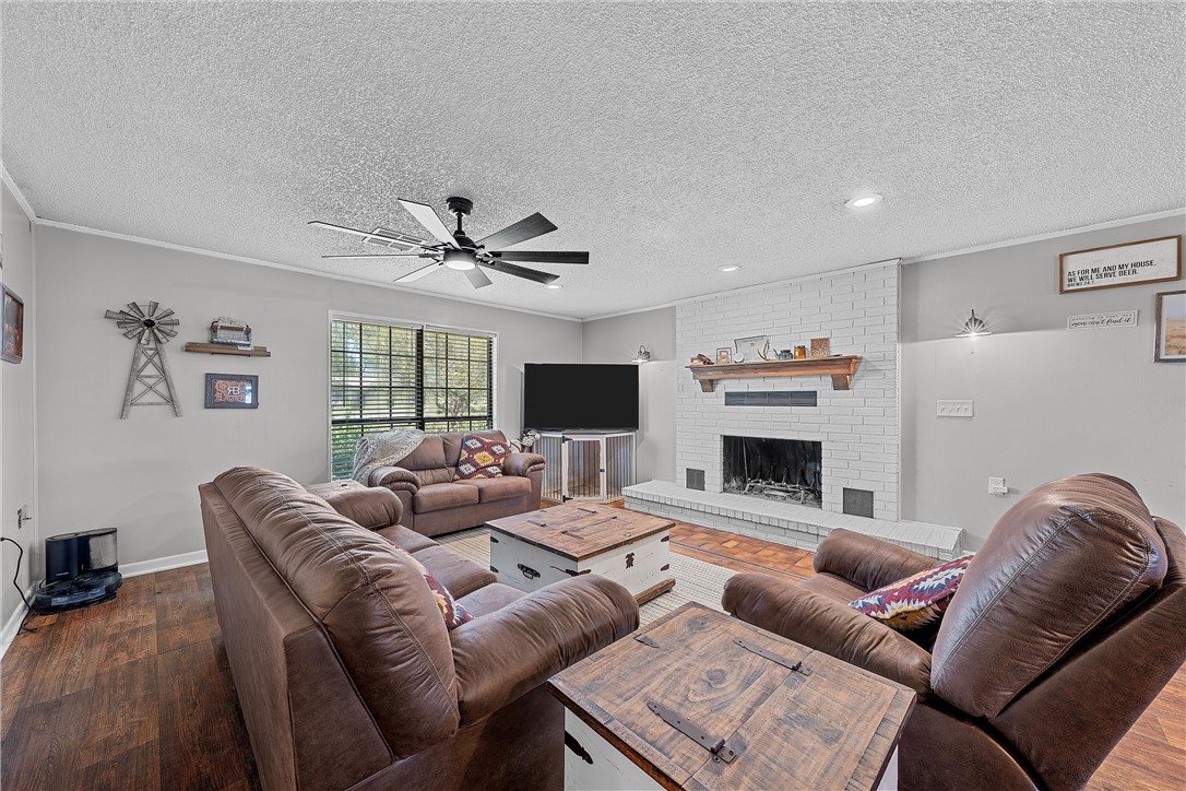 126 Cr 173 Road Marlin, TX 76661 - Photo 6 of 48 a living room with furniture a fireplace and a flat screen tv