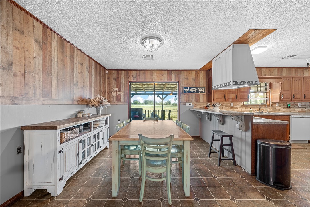 126 Cr 173 Road Marlin, TX 76661 - Photo 9 of 48 a kitchen with stainless steel appliances granite countertop a stove top oven a sink dishwasher and white cabinets with wooden floor