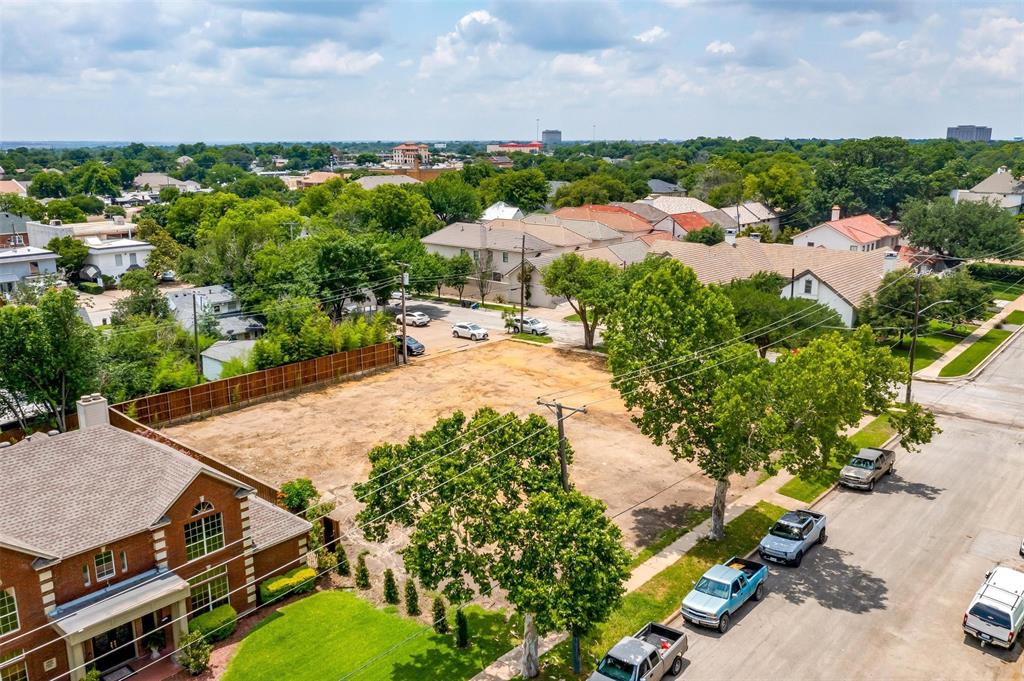 an aerial view of a house with a yard and lake view