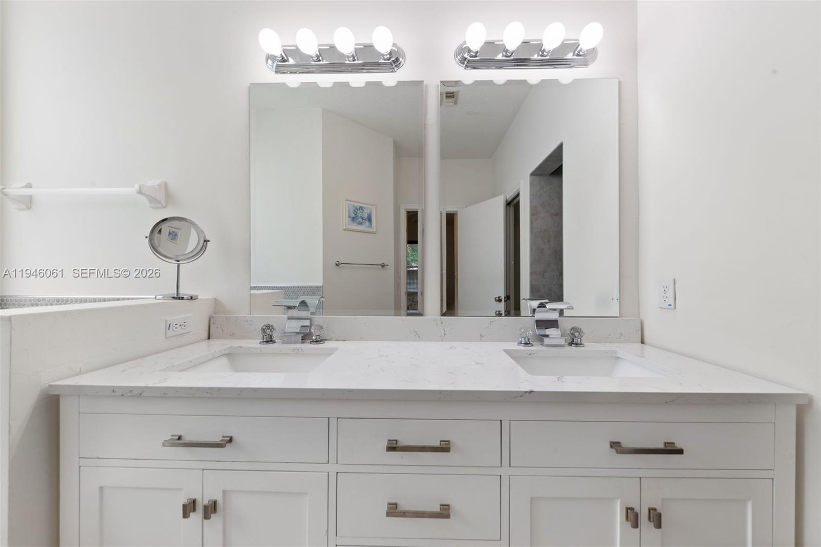 15932 Southwest 146th Terrace Miami, FL 33196 - Photo 15 of 25 a bathroom with a double vanity sink and a mirror