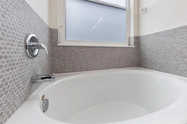 a white bath tub sitting in a bathroom