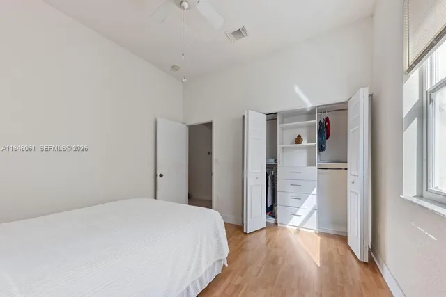 a bedroom with a bed and a window