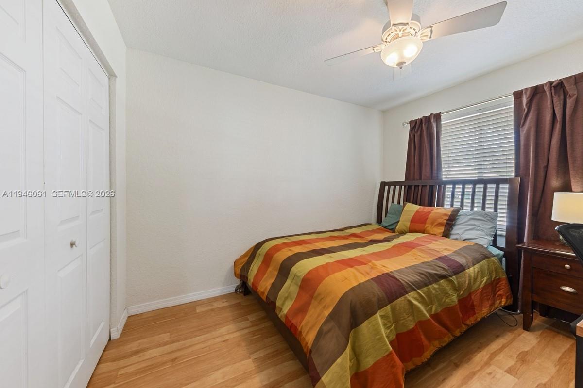 15932 Southwest 146th Terrace Miami, FL 33196 - Photo 20 of 25 a bedroom with a bed and a chandelier