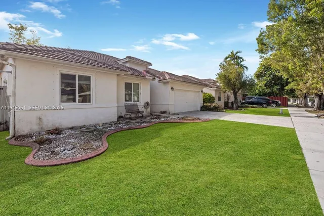 a front view of house with yard and outdoor seating