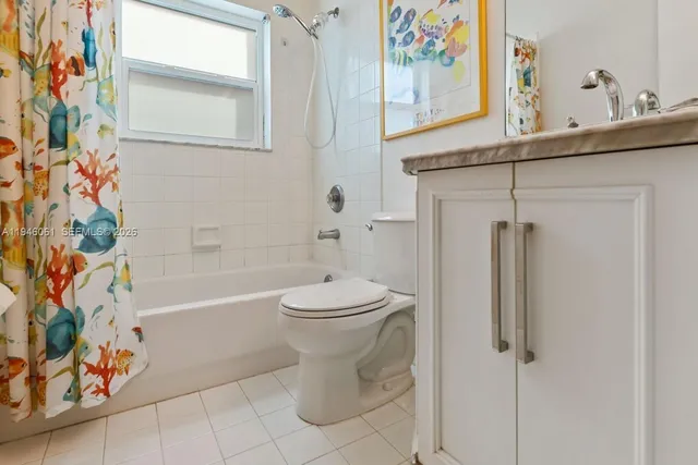 a bathroom with a toilet and a shower curtain