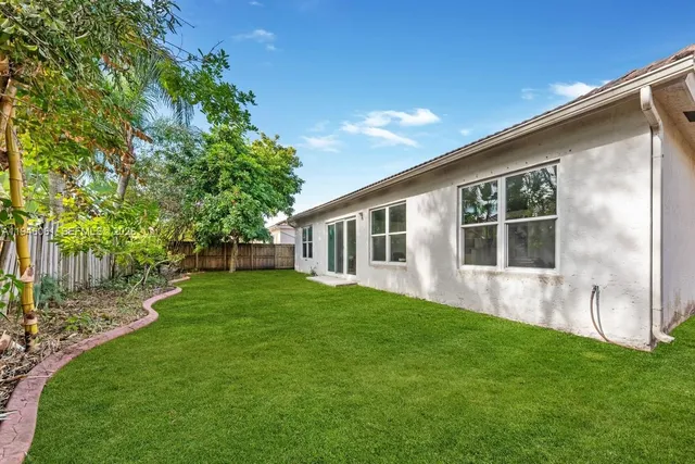 a front view of house with a garden and patio