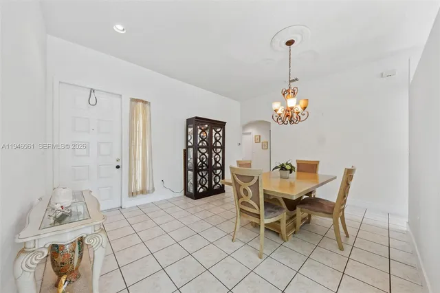 a view of a dining room with furniture and chandelier