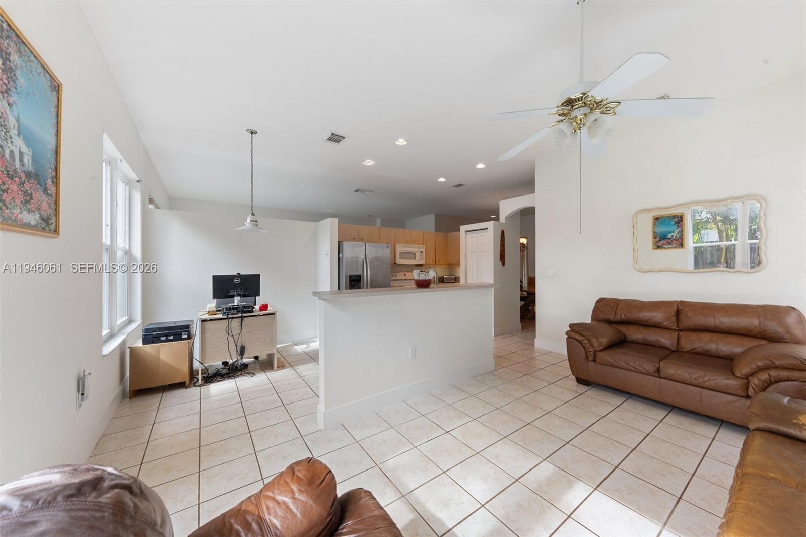 15932 Southwest 146th Terrace Miami, FL 33196 - Photo 5 of 25 a living room with furniture and a chandelier