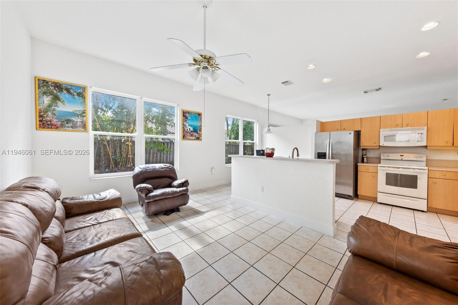 15932 Southwest 146th Terrace Miami, FL 33196 - Photo 8 of 25 a living room with furniture and a large window