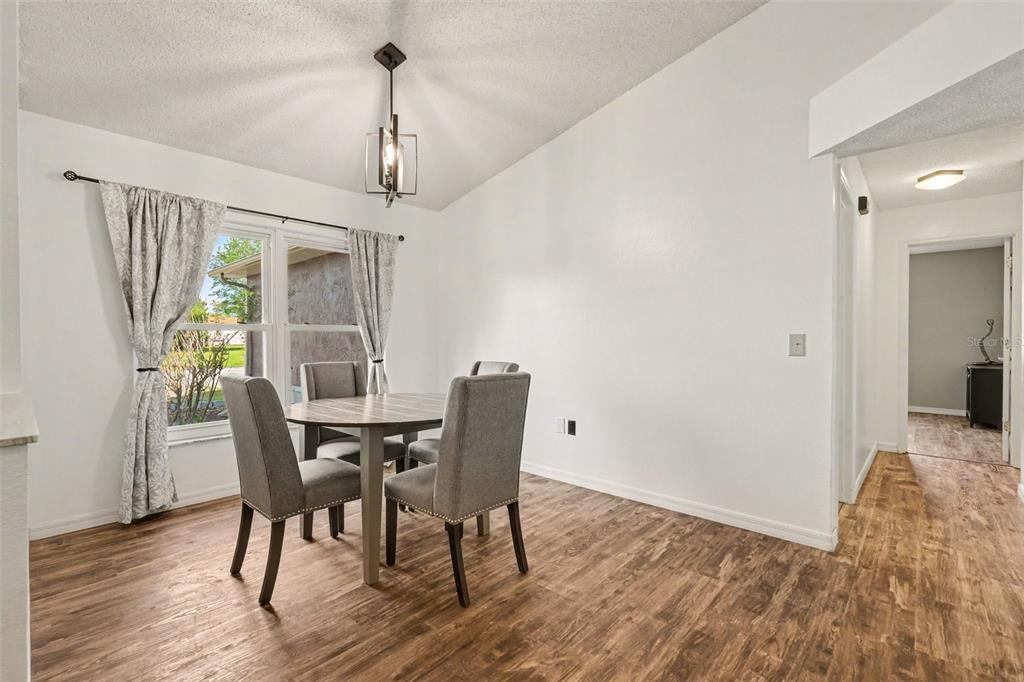 4156 Weldon Avenue Spring Hill, FL 34609 - Photo 11 of 26 a view of a dining room with furniture window and wooden floor