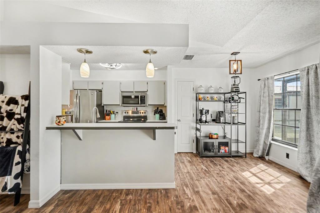 4156 Weldon Avenue Spring Hill, FL 34609 - Photo 13 of 26 a open kitchen with stainless steel appliances granite countertop a refrigerator and microwave