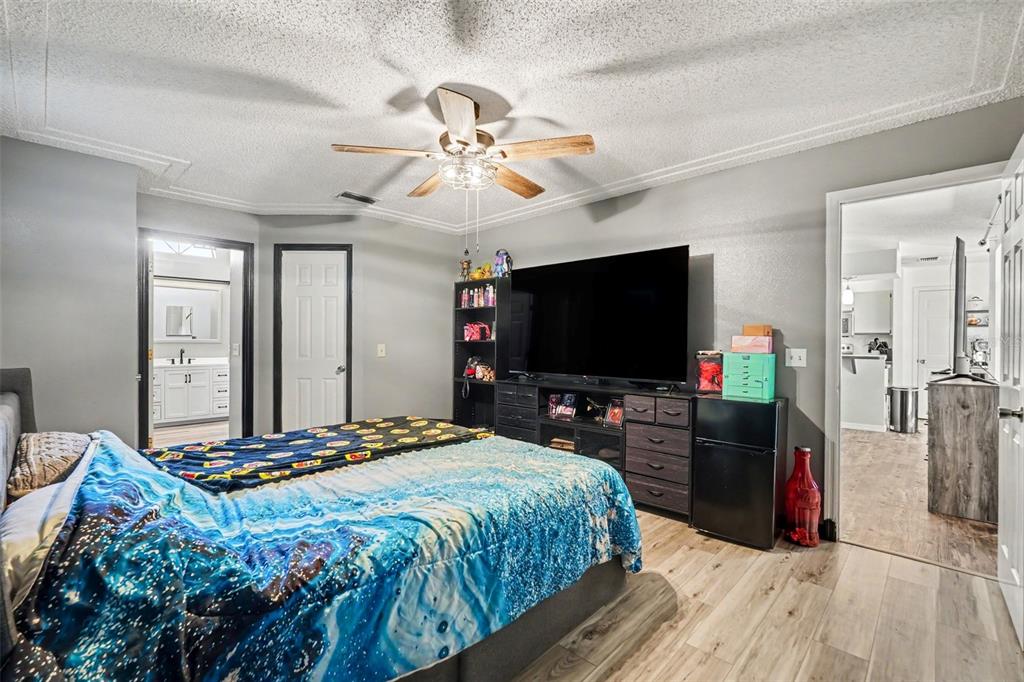4156 Weldon Avenue Spring Hill, FL 34609 - Photo 15 of 26 a bedroom with a bed and a flat screen tv