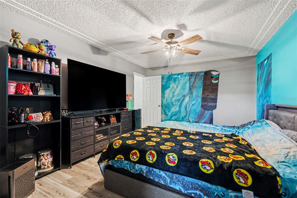 4156 Weldon Avenue Spring Hill, FL 34609 - Photo 16 of 26 a bedroom with a bed and a flat screen tv