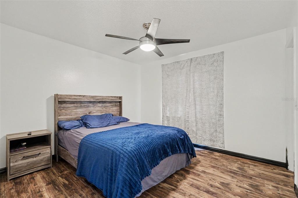 4156 Weldon Avenue Spring Hill, FL 34609 - Photo 17 of 26 a bedroom with a bed and a ceiling fan