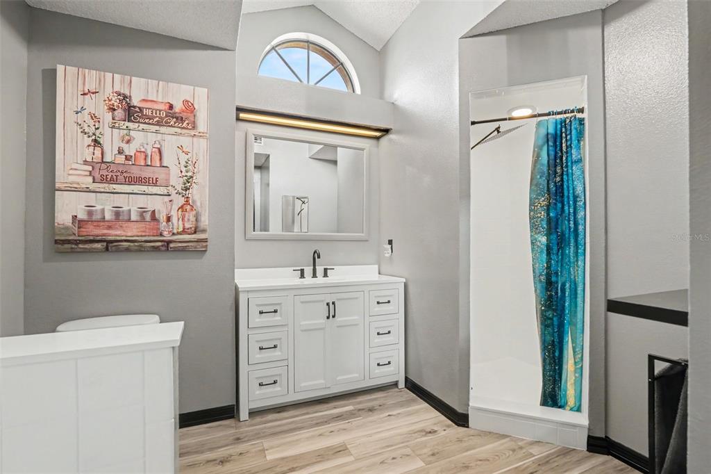 4156 Weldon Avenue Spring Hill, FL 34609 - Photo 20 of 26 a bathroom with a sink a mirror and a toilet