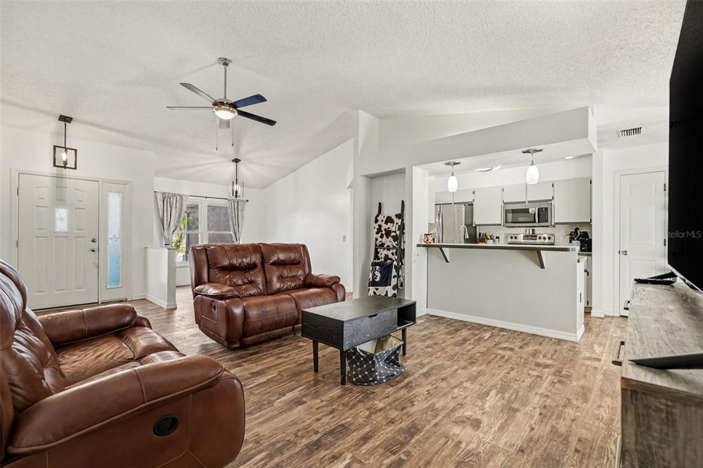 4156 Weldon Avenue Spring Hill, FL 34609 - Photo 3 of 26 a living room with furniture and kitchen view