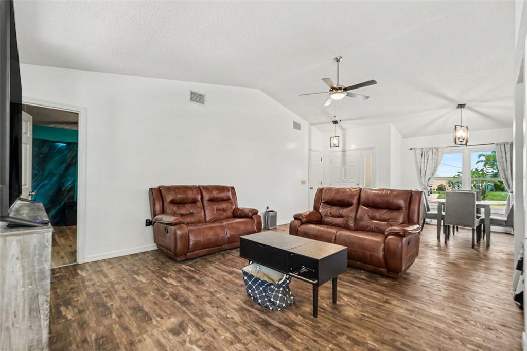 4156 Weldon Avenue Spring Hill, FL 34609 - Photo 8 of 26 a living room with furniture and wooden floor