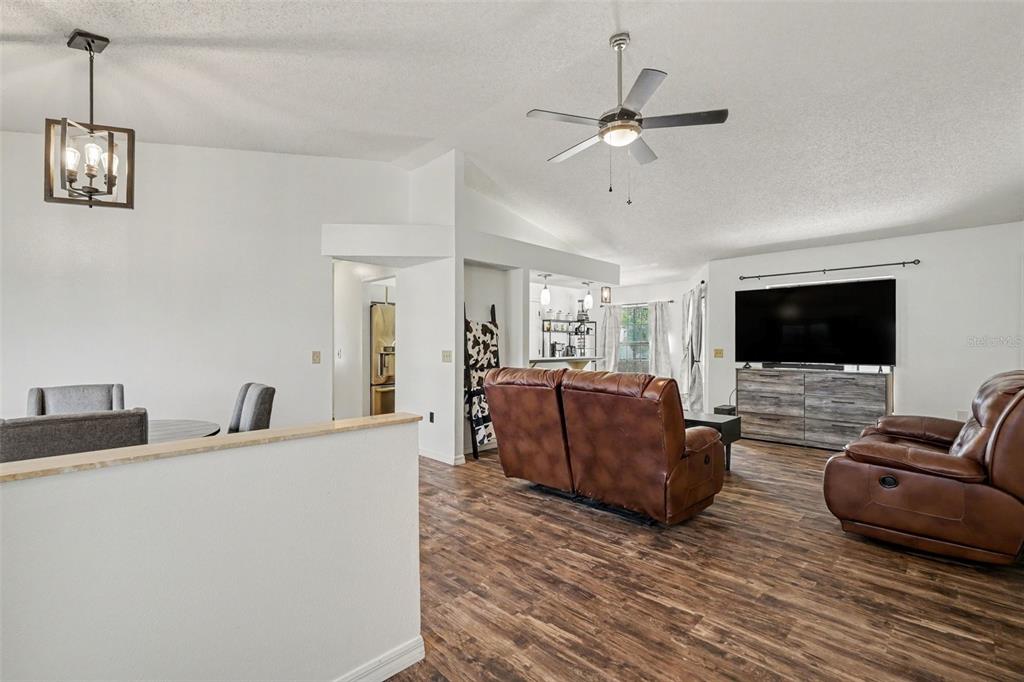 4156 Weldon Avenue Spring Hill, FL 34609 - Photo 9 of 26 a living room with furniture and a flat screen tv