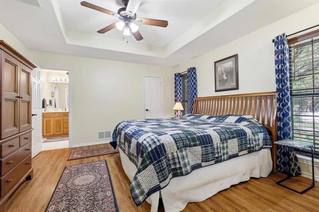 6000 Jackson Road Krum, TX 76249 - Photo 12 of 40 a bedroom with a bed and wooden floor