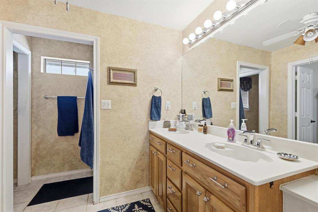6000 Jackson Road Krum, TX 76249 - Photo 14 of 40 a bathroom with a sink vanity and a mirror