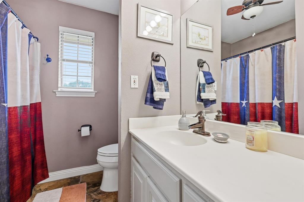 6000 Jackson Road Krum, TX 76249 - Photo 18 of 40 a bathroom with a sink vanity mirror and toilet