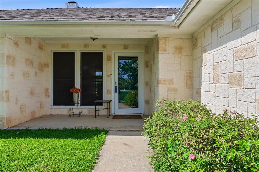 6000 Jackson Road Krum, TX 76249 - Photo 3 of 40 a front view of a house with a porch