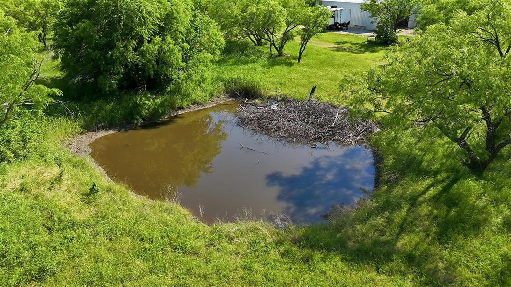 6000 Jackson Road Krum, TX 76249 - Photo 36 of 40 a view of a lake with a yard