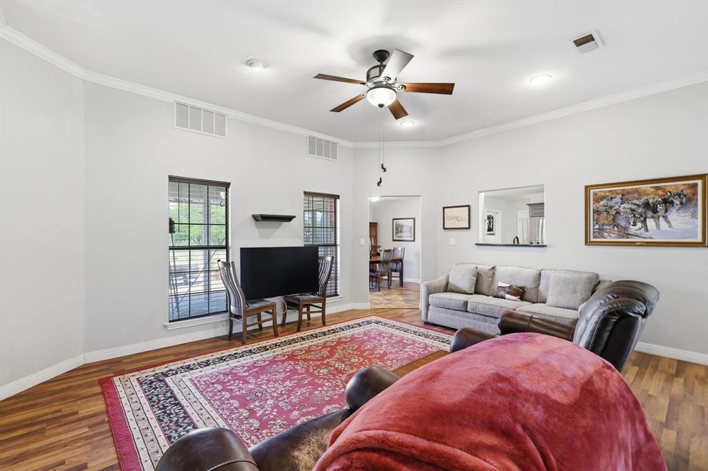 6000 Jackson Road Krum, TX 76249 - Photo 7 of 40 a living room with furniture a rug and a flat screen tv