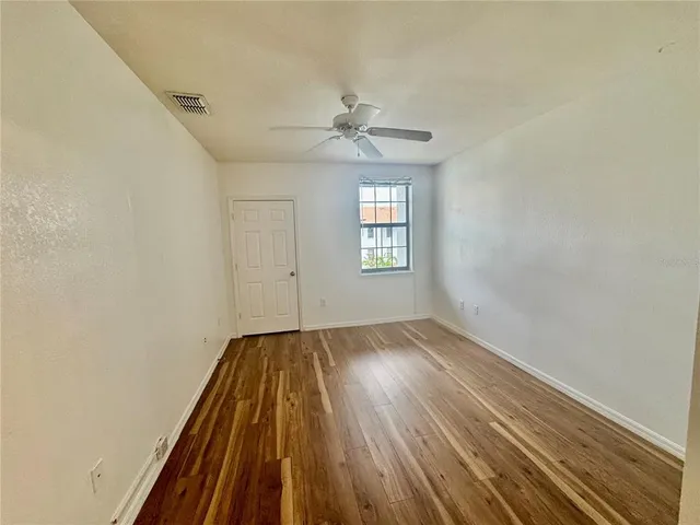 wooden floor in an empty room with a window