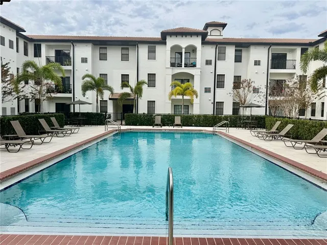 a swimming pool view with a outdoor seating space