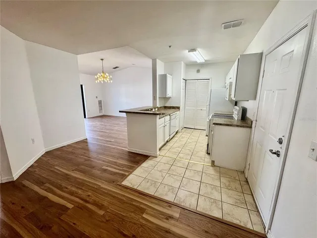 a kitchen with stainless steel appliances a refrigerator and a stove top oven