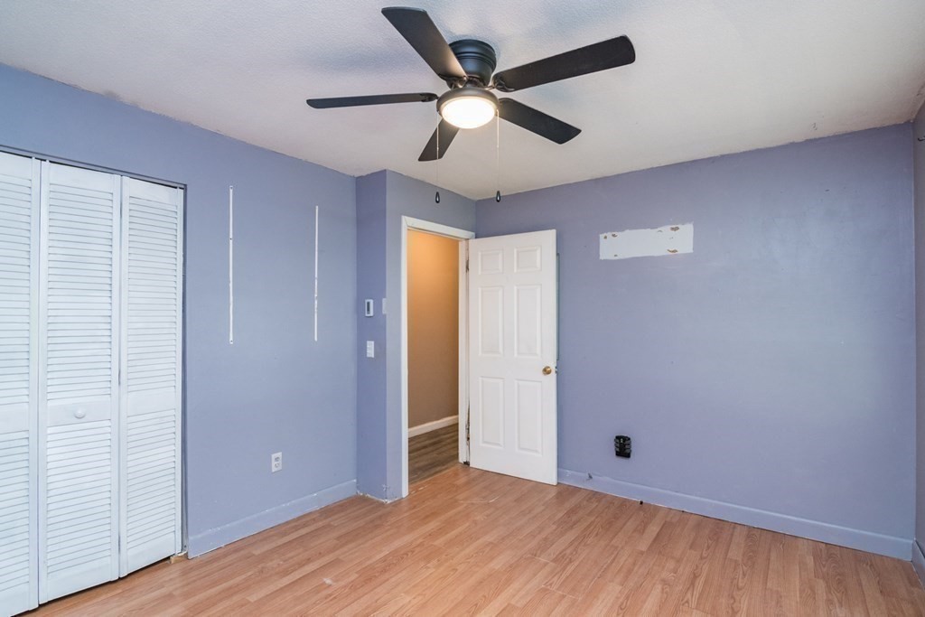 160 Vincent Street Springfield, MA 01129 - Photo 9 of 26 a view of an empty room with wooden floor and a ceiling fan