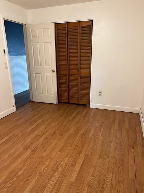 160 Vincent Street Springfield, MA 01129 - Photo 10 of 26 an empty room with wooden floor and cabinet