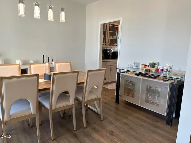 a view of a dining room with a table and chairs