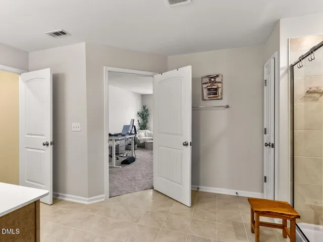 a spacious bathroom with a shower sink and mirror
