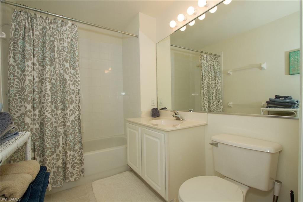 23770 Clear Spring Court, Unit 1402 Estero, FL 34135 - Photo 12 of 17 a bathroom with a sink a toilet and shower