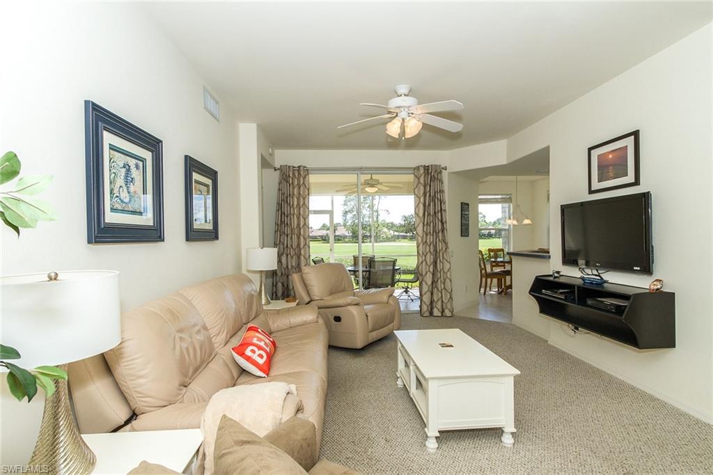 23770 Clear Spring Court, Unit 1402 Estero, FL 34135 - Photo 3 of 17 a living room with furniture and a flat screen tv