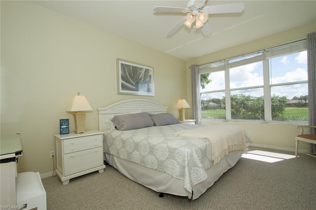 23770 Clear Spring Court, Unit 1402 Estero, FL 34135 - Photo 8 of 17 a bedroom with a bed and a window
