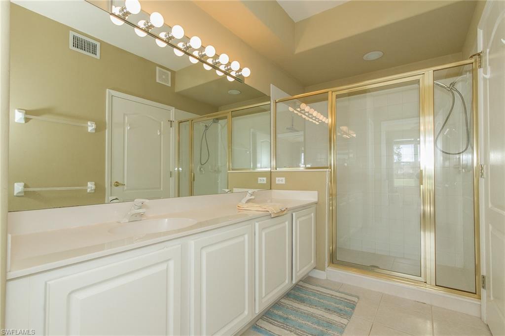 23770 Clear Spring Court, Unit 1402 Estero, FL 34135 - Photo 10 of 17 a spacious bathroom with a shower sink and mirror