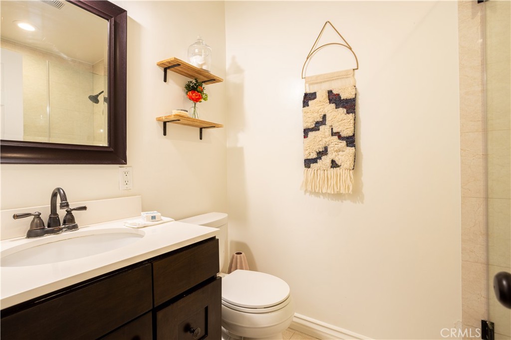 1514 Pilgrim Way Monrovia, CA 91016 - Photo 17 of 47 a bathroom with a sink a toilet and mirror