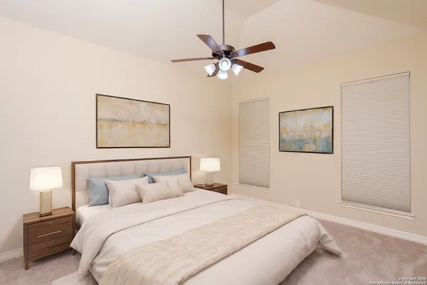 a bedroom with a bed and a painting on the wall