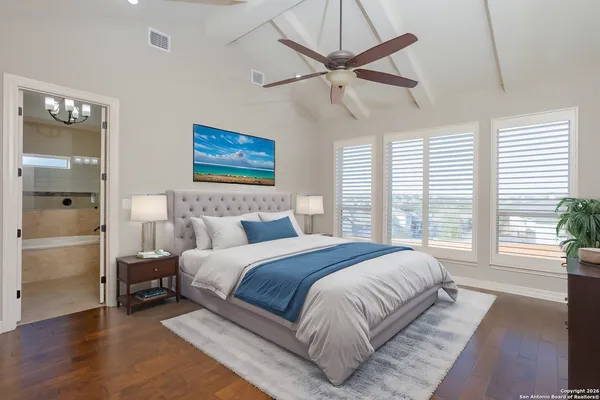 a spacious bedroom with a large bed and a window