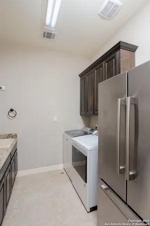a kitchen with a stove and a refrigerator