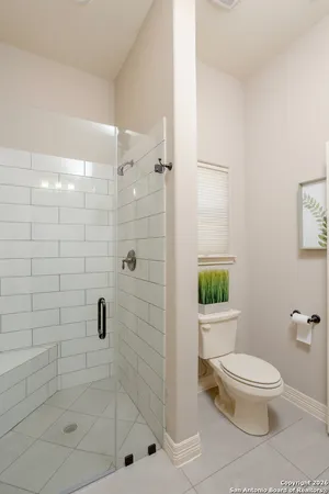 a white toilet and shower