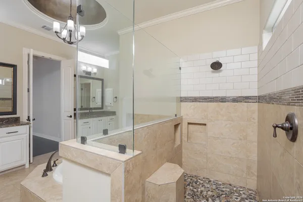 a bathroom with a sink a toilet a mirror and shower