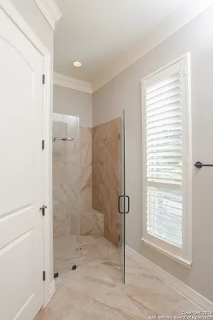 a bathroom with a shower and a sink