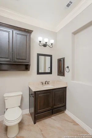 a bathroom with a toilet sink and mirror